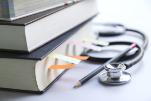 Career pathways in Appalachia | Medical student textbooks with pencil and multicolor bookmarks and stethoscope isolated on white